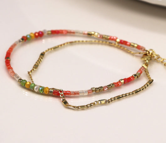 Coral beads and golden chain layered bracelet
