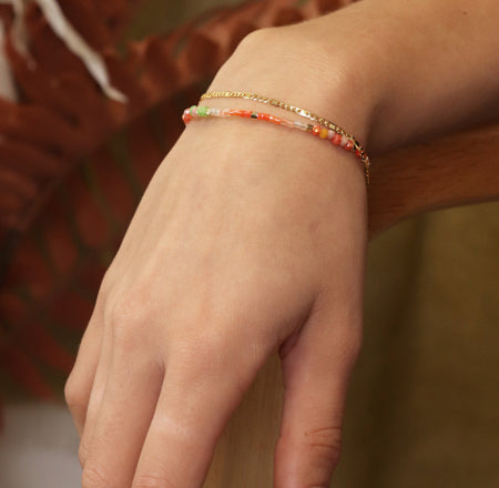 Coral beads and golden chain layered bracelet