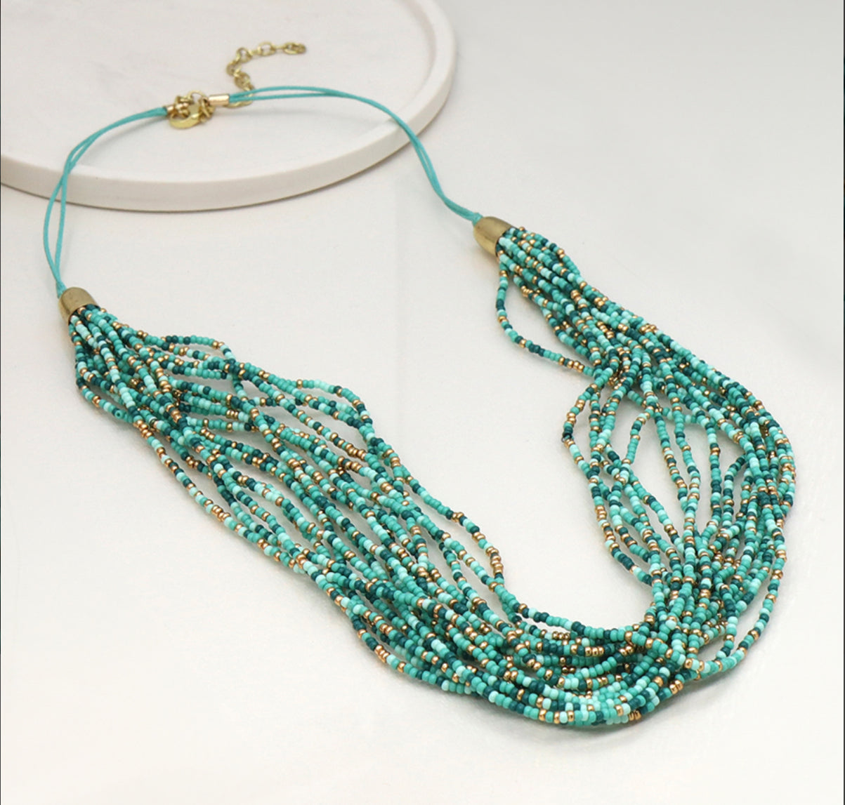 Aqua mix multi strand necklace with golden fastening