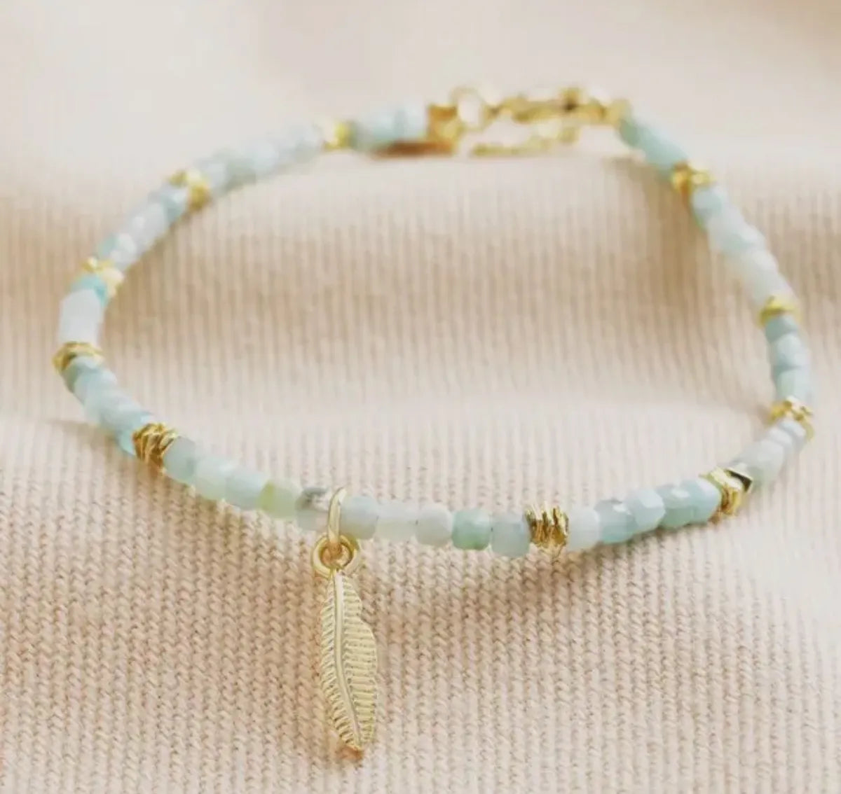 Gold amozonite bracelet with feather charm