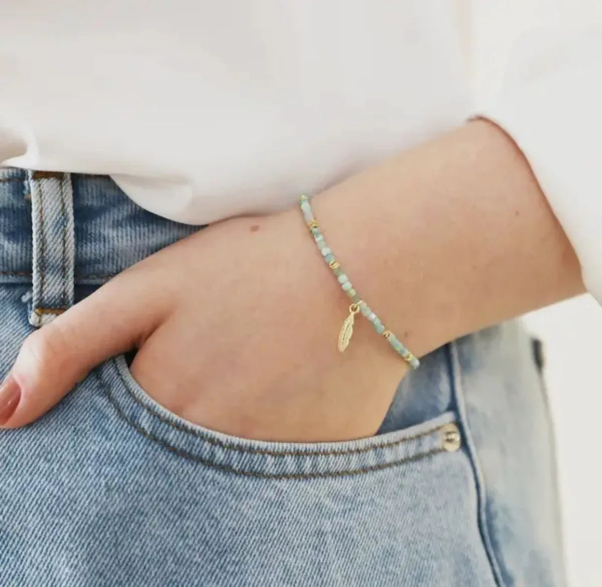 Gold amozonite bracelet with feather charm