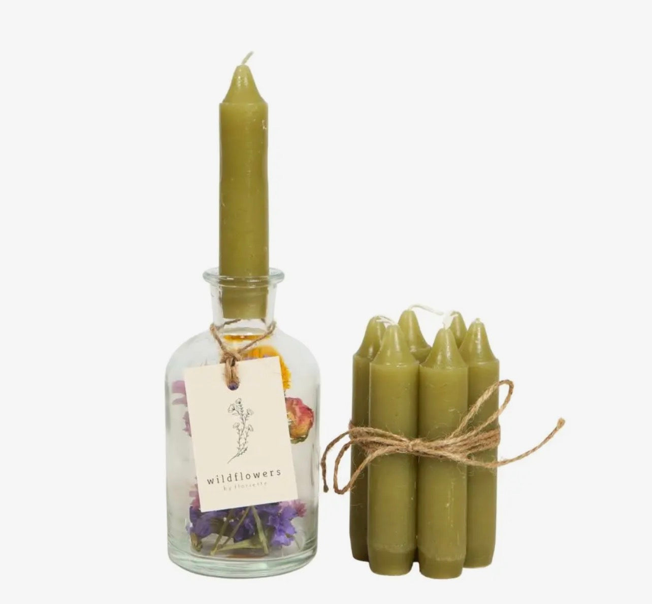 Set of green candles, including a bottle with dried flowers and a bundle of candles tied with twine on a white background.