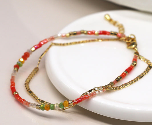 Coral beads and golden chain layered bracelet