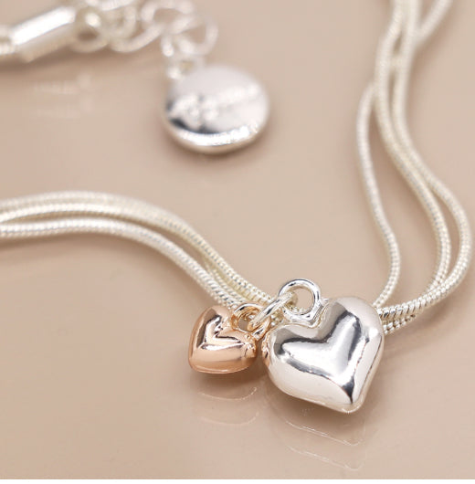 Triple silver chain bracelet with double heart