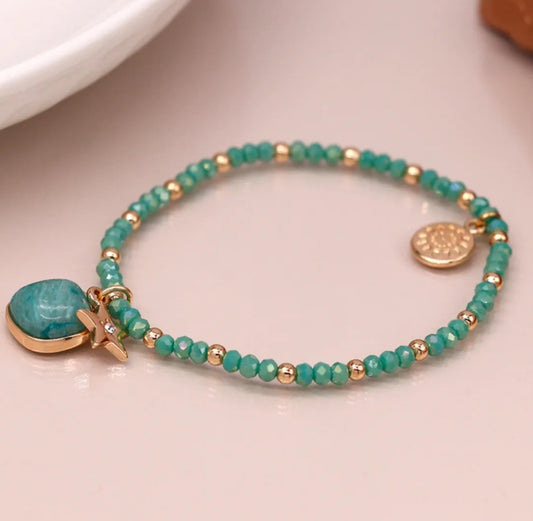 Sea green and golden charm bracelet with star and stone
