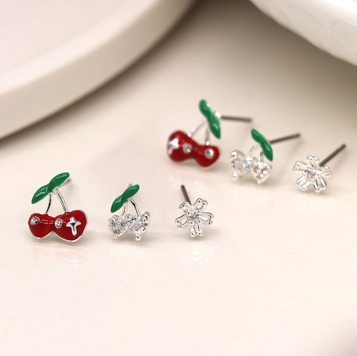Silver plated cherry and flower triple stud set